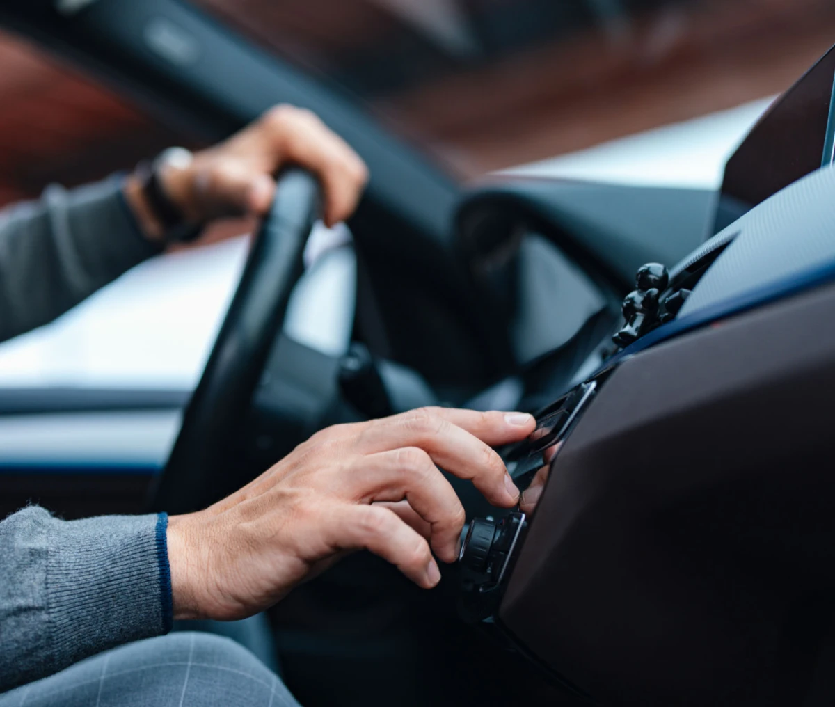 Driver adjusting car radio controls